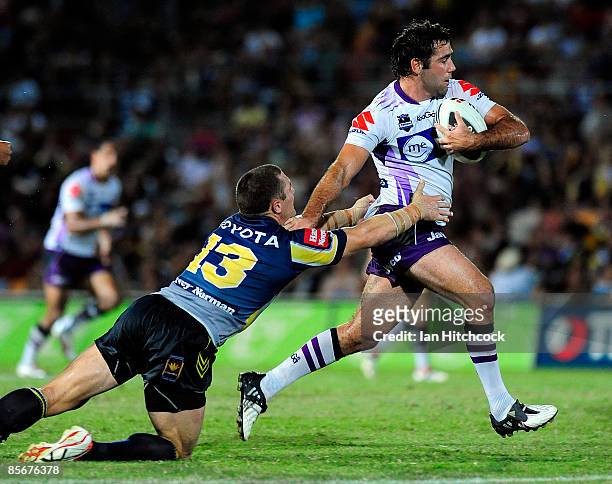 Cameron Smith of the Storm skips out of a tackle of Luke O'Donnell of the Cowboys during the round three NRL match between the North Queensland...
