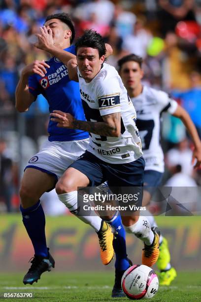 Francisco Silva of Cruz Azul struggles for the ball with Mauro Formica of Pumas during the 12th round match between Pumas UNAM and Cruz Azul as part...