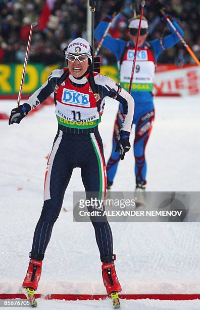 Italian Michela Ponza crosses the finish line in second place as French Marie Dorin follows in third during the women's 10 km sprint at the World Cup...