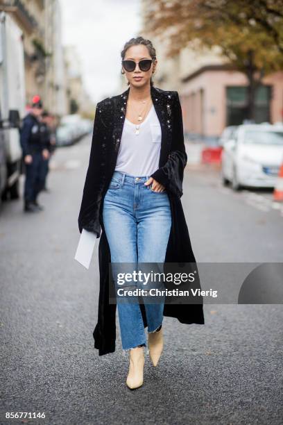 Aimee Song with braids hair, wearing denim jeans, black coat seen outside Sacai during Paris Fashion Week Spring/Summer 2018 on October 2, 2017 in...