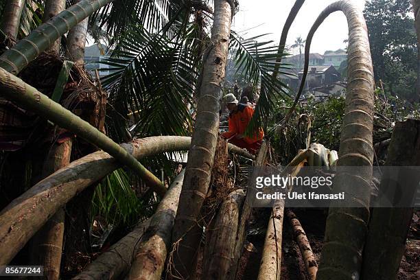 Search and rescue workers search for dam-burst victims on March 28, 2009 in Ciputat, Indonesia. As the official death toll rises to 77, Indonesian...