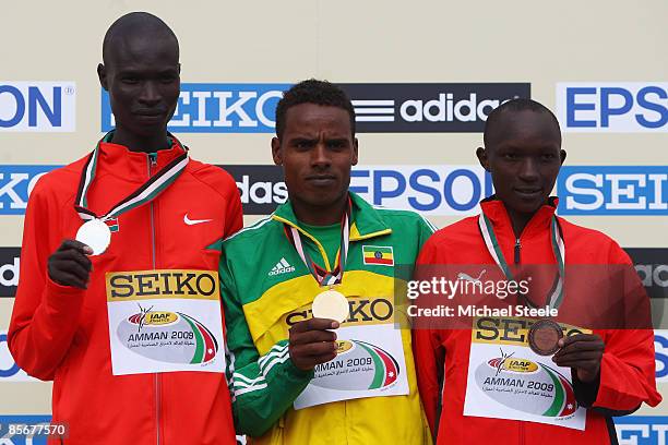 Ayele Abshero of Ethiopia winner of gold in the men's junior race, with silver medalist Titus Kipjumba Mbishei of Kenya and bronze medalist Moses...