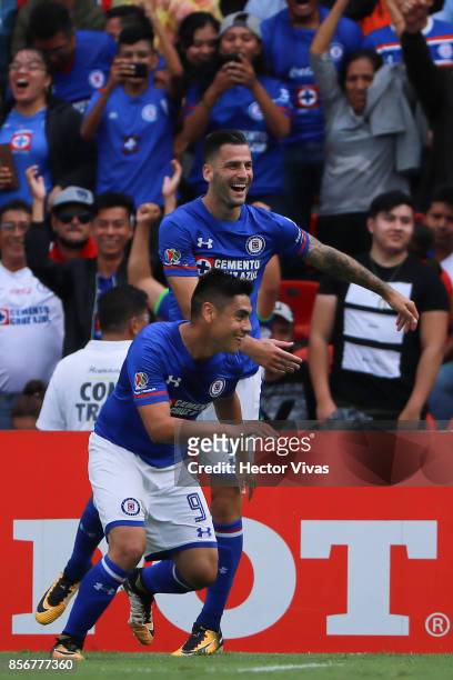 Felipe Mora of Cruz Azul celebrates with teammates after scoring the third goal of his team during the 12th round match between Pumas UNAM and Cruz...