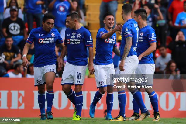 Felipe Mora of Cruz Azul celebrates with teammates after scoring the third goal of his team during the 12th round match between Pumas UNAM and Cruz...