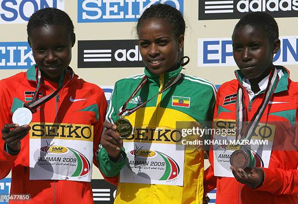 Ethiopia's gold medallist Genzebe Dibaba , Kenya's silver medallist Mercy Cherono and her bronze medallist compatriot Jackline Chepgnego stand on the...
