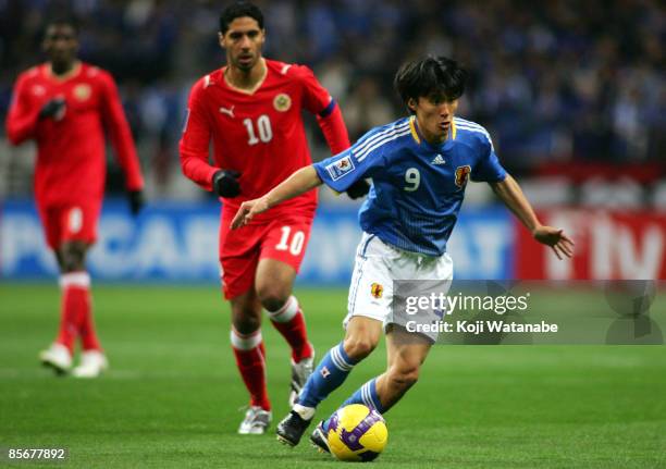 Tatsuya Tanaka of Japan in action against Mohammed Salmeen of Bahrain during the 2010 FIFA World Cup Asian qualifier match between Japan and Bahrain...