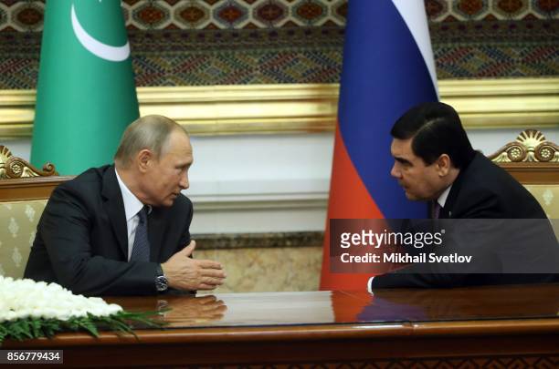 Turkmen President Gurbanguly Berdimuhamedow listens to Russian President Vladimir Putin during their meeting October 2, 2017 in Ashgabad,...