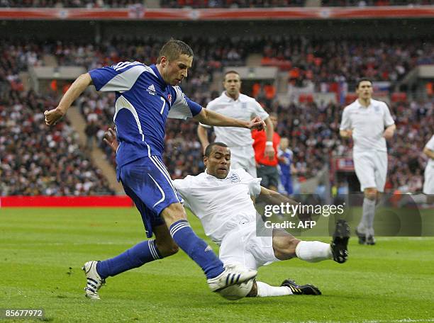 Ashley Cole of England defends against the shot from Stanislav Sestak of Slovakia during their International friendly match at Wembley Stadium in...