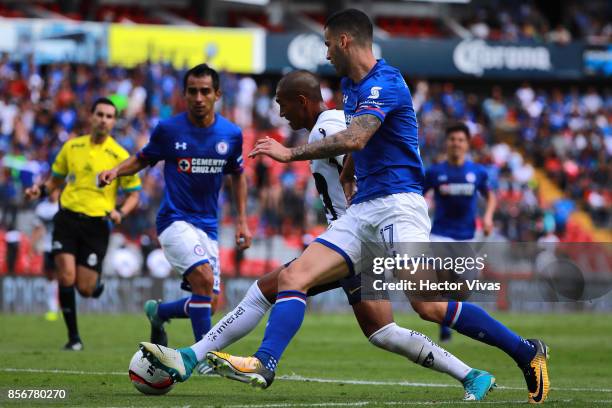 Edgar Mendez of Cruz Azul struggles for the ball with Bryan Silva of Pumas during the 12th round match between Pumas UNAM and Cruz Azul as part of...