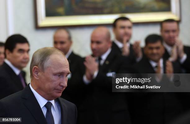 Turkmen President Gurbanguly Berdimuhamedow and Russian President Vladimir Putin enter the hall during their meeting October 2, 2017 in Ashgabad,...