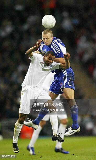 England defender Ashley Cole scuffles with Slovak midfielder Marek Sapara during their International friendly football match at Wembley Stadium in...