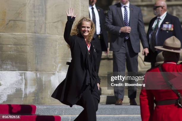 Julie Payette, governor general of Canada, waves while arriving in front of Parliament Hill for inspect the guard for the first time in Ottawa,...