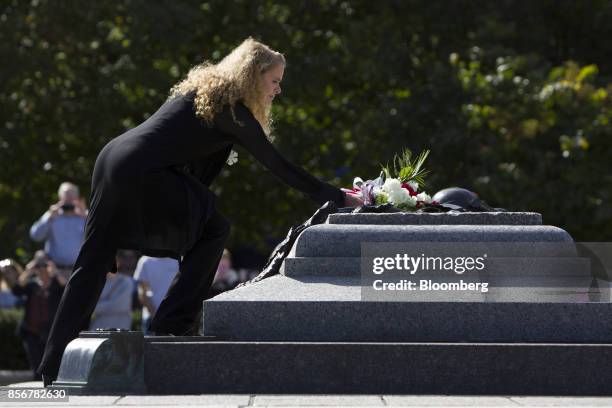 Julie Payette, governor general of Canada, lays flowers at the National War monument after being sworn on Parliament Hill in Ottawa, Ontario, Canada,...