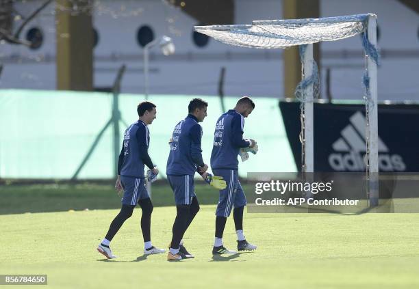 Argentina's goalkeepers Agustin Marchesin, Nahuel Guzman, and Sergio Romero arrive to a training session in Ezeiza, Buenos Aires on October 2, 2017...