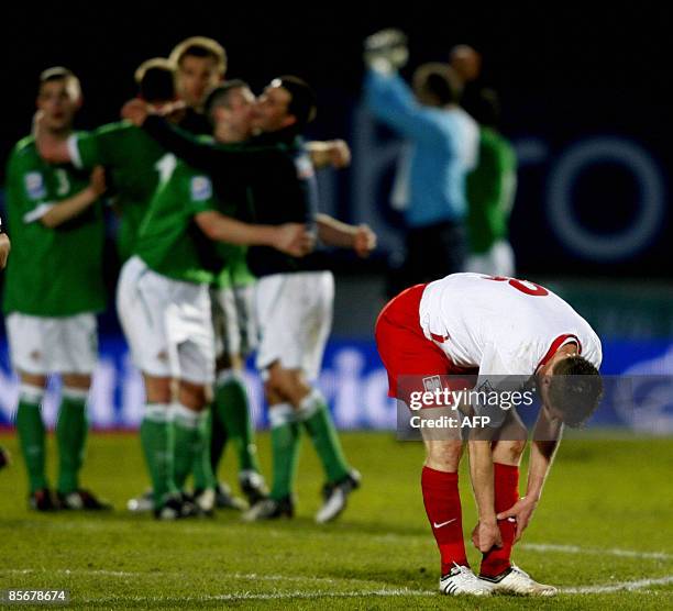 Northern Ireland team players celebrate their win against Poland as Poland's Dariusz Dudka reacts during a World Cup qualifing football match at...