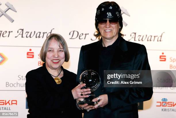 Gottfried Helnwein presents his award with Antje Vollmer during the Steiger Awards ceremony at the Jahrhunderthalle on March 28 in Bochum, Germany.