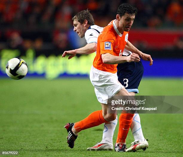 Gary Naysmith of Scotland tackles Mark van Bommel of Netherlands during the FIFA 2010 World Cup qualifying match between Netherlands and Scotland at...