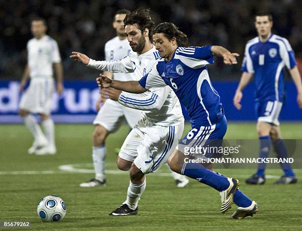 Greece's Georgios Samaras vies for the ball with Israel's Dedi Ben Dayan during their 2010 World Cup European zone group 2 qualifying football match...