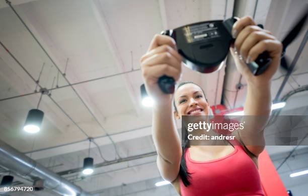 woman at the gym checking her progress with a body scanner - security scanner stock pictures, royalty-free photos & images