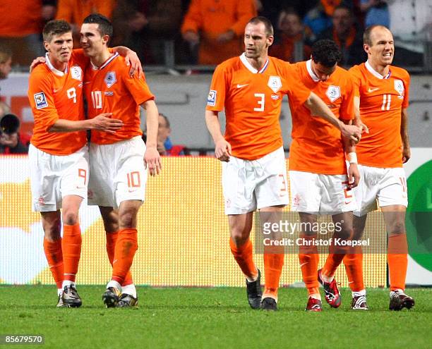 Klaas-Jan Huntelaar of Netherlands celebrates the second goal with Robin van Persie c during the FIFA 2010 World Cup qualifying match between...