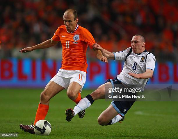 Arjen Robben of Holland is challenged by Scott Brown of Scotland during the FIFA2010 World Cup Group 9 Qualifier between Netherlands and Scotland at...