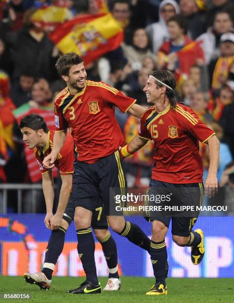 Spain's defender Gerard Piqué celebrates with teammates defender Sergio Ramos after scoring against Turkey during their 2010 FIFA World Cup...