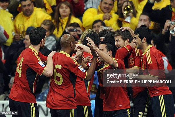Spain's defender Gerard Piqué celebrates with teammates after scoring against Turkey during their 2010 FIFA World Cup qualification match at Santiago...