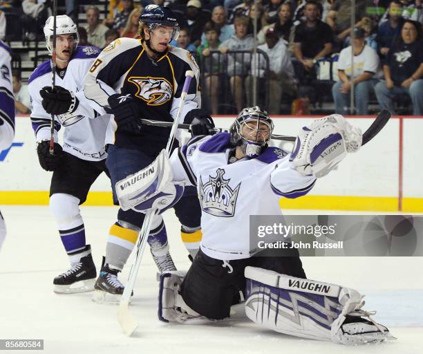 Jonathan Quick of the Los Angeles Kings makes a glove save against Cal O'Reilly of the Nashville Predators at the Sommet Center on March 28, 2009 in...