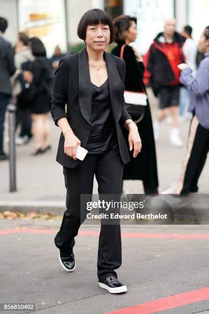 Angelica Cheung wears a black suit, outside Shiatzy Chen, during Paris Fashion Week Womenswear Spring/Summer 2018, on October 2, 2017 in Paris,...