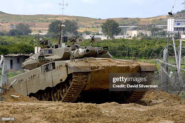 An Israeli-made Merkava tank returns towards Israeli territory after action February 13, 2002 in the northern Gaza Strip. Three Israeli soldiers were...