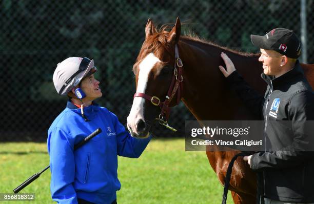 Jockey Craig Williams and strapper Matt Scown pose with Admire Deus from Japan after a trackwork session at Werribee Racecourse on October 3, 2017 in...