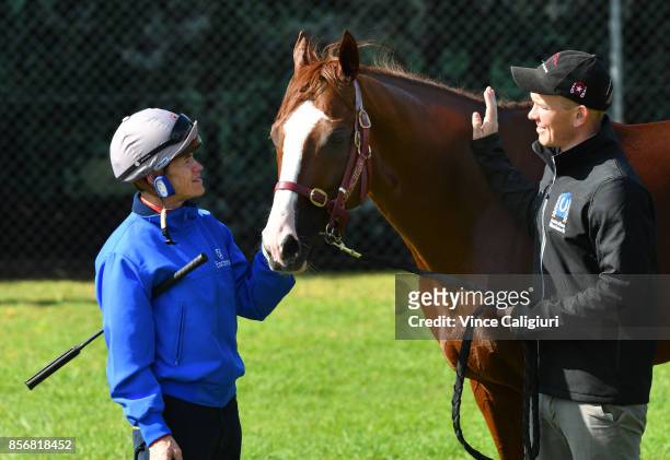 Jockey Craig Williams and strapper Matt Scown pose with Admire Deus from Japan after a trackwork session at Werribee Racecourse on October 3, 2017 in...