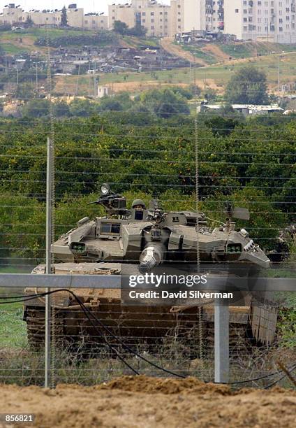 An Israeli-made Merkava tank returns towards Israeli territory after action February 13, 2002 in the northern Gaza Strip. Three Israeli soldiers were...