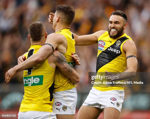 Shane Edwards of the Tigers celebrates with Dustin Martin and Dion Prestia during the 2017 Toyota AFL Grand Final match between the Adelaide Crows...