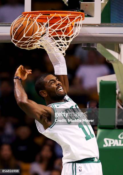 Kyrie Irving of the Boston Celtics scores against the Charlotte Hornets during the first half at TD Garden on October 2, 2017 in Boston,...