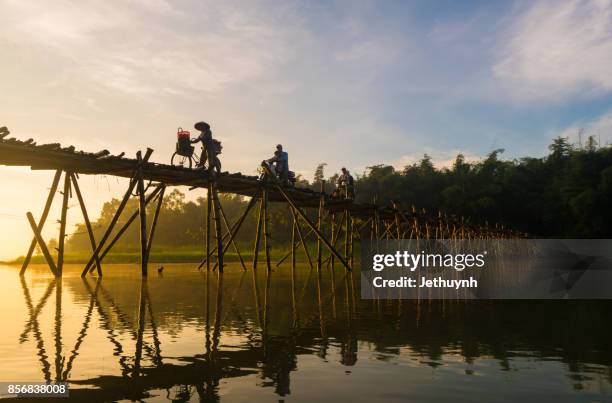 people moving at bamboo bridge at countryside quang ngai vietnam in the early morning - quảng ngãi stock pictures, royalty-free photos & images