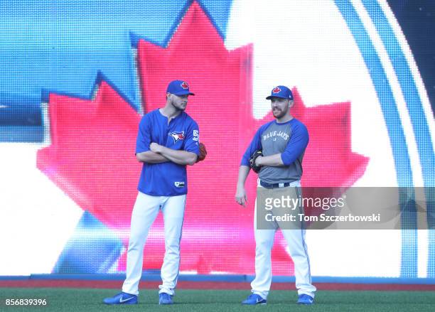 Matt Dermody of the Toronto Blue Jays and Danny Barnes look on from the outfield during batting practice before the start of MLB game action against...