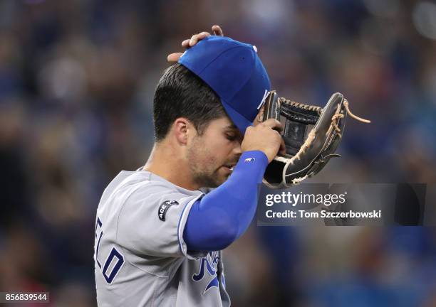 Whit Merrifield of the Kansas City Royals adjusts his cap during MLB game action against the Toronto Blue Jays at Rogers Centre on September 21, 2017...