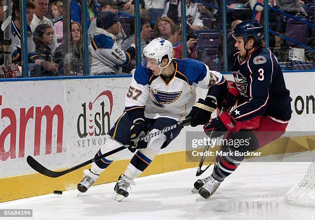 David Perron of the St. Louis Blues skates against Marc Methot of the Columbus Blue Jackets on March 28, 2009 at Scottrade Center in St. Louis,...