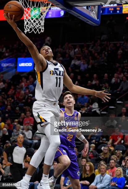 Dante Exum of the Utah Jazz scores in front of Dane Pineau of the Sydney Kings in the first half of their preseason game at Vivint Smart Home Arena...