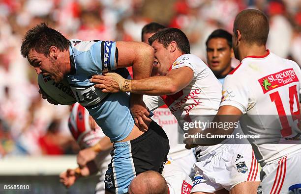 Luke Douglas of the Sharks is tackled during the round three NRL match between the St George Illawarra Dragons and the Cronulla Sharks at WIN Jubilee...