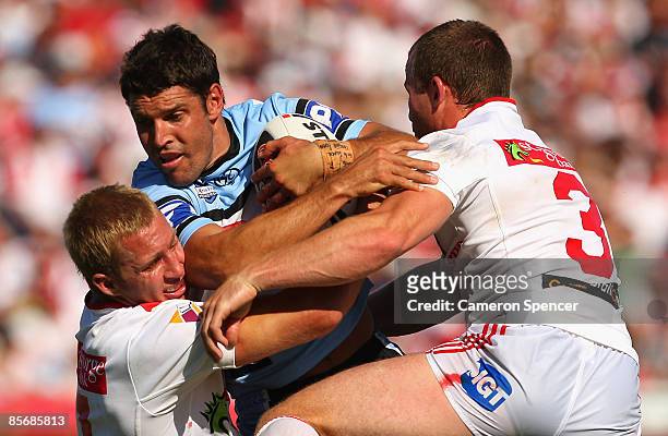 Trent Barrett of the Sharks is tackled during the round three NRL match between the St George Illawarra Dragons and the Cronulla Sharks at WIN...