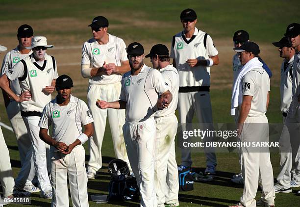 New Zealand cricket captain Daniel Vettori reacts as he and teammates wait for Indian players to return to the pitch during the fourth day of the...