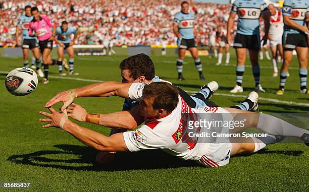Brett Morris of the Dragons contests the ball with David Simmons of the Sharks during the round three NRL match between the St George Illawarra...