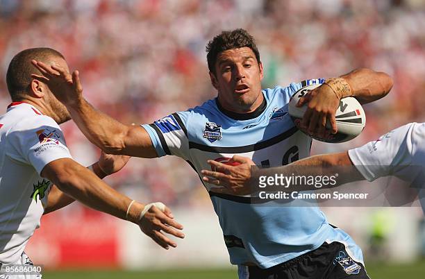 Trent Barrett of the Sharks runs through the Dragons defence during the round three NRL match between the St George Illawarra Dragons and the...