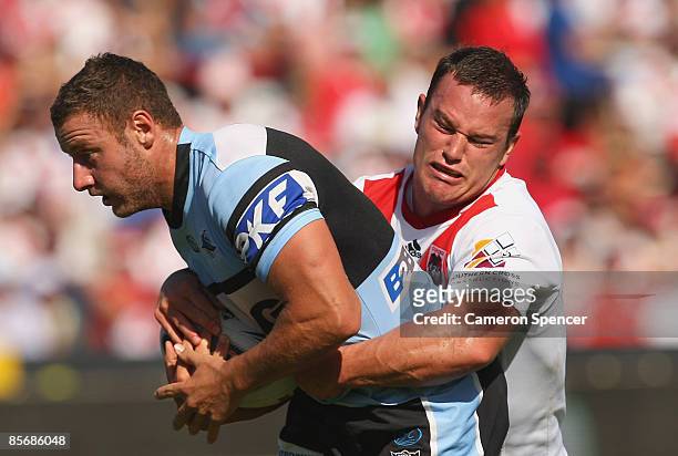 Blake Green of the Sharks is tackled during the round three NRL match between the St George Illawarra Dragons and the Cronulla Sharks at WIN Jubilee...