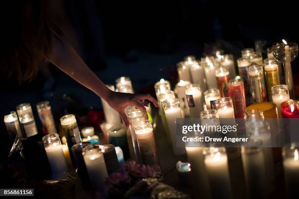 Mourners attend a candlelight vigil at the corner of Sahara Avenue and Las Vegas Boulevard for the victims of Sunday night's mass shooting, October...