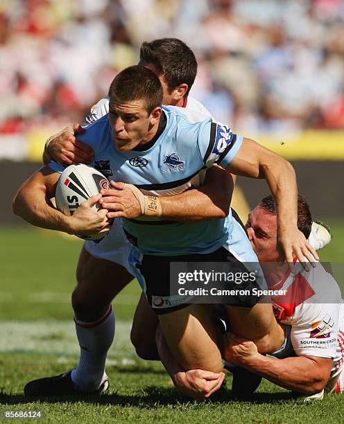 Tony Caine of the Sharks is tackled during the round three NRL match between the St George Illawarra Dragons and the Cronulla Sharks at WIN Jubilee...
