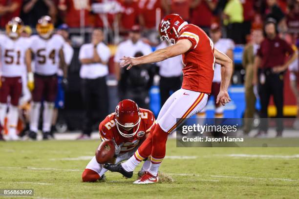 Kicker Harrison Butker of the Kansas City Chiefs kicks a go ahead field goal from the hold of teammate Dustin Colquitt with eight seconds left during...