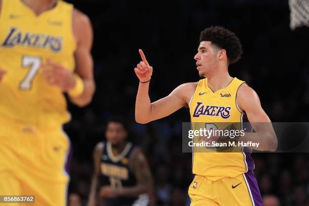 Lonzo Ball of the Los Angeles Lakers motions to the crowd during the first half of a preseason game against the Denver Nuggets at Staples Center on...